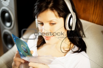 Beautiful woman listening music in headphones