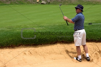Golfer in the bunker.