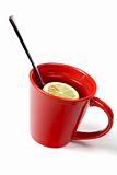 Red cup of tea with lemon and the spoon