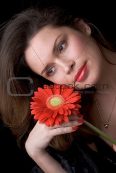 Beautiful lady with red gerber. Portrait