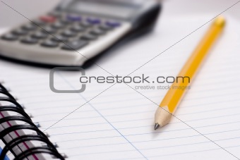 pencil and calculator on notebook