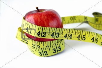Apple with measuring tape around in white background