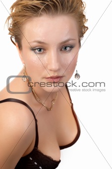 Young sexy blond woman in black bra, with water drops on her face and wet hair. Isolated on white.