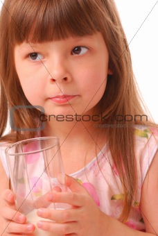 Girl with milk-moustache holding glass of milk