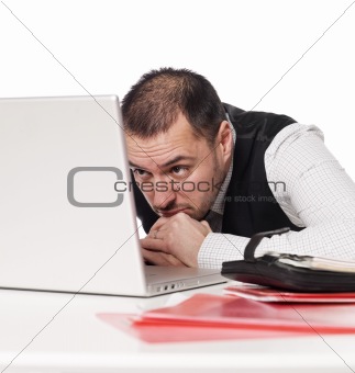 Man at the office studying a laptop