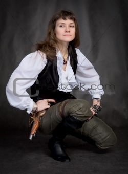 Girl - pirate with pistol sit on black