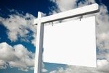 Blank Real Estate Sign on Clouds & Sky Background - Ready for your own message.