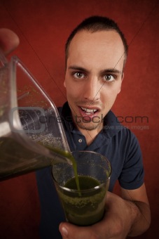 Young man with unappetizing health shake