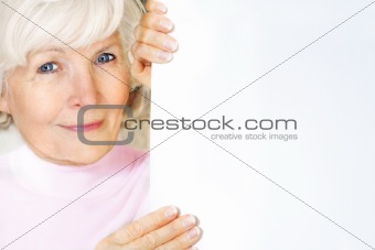 Senior woman holding board