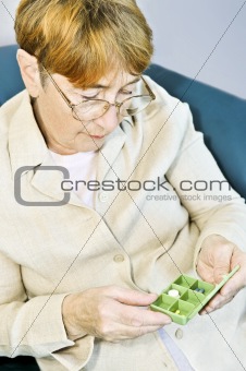 Elderly woman with pill box
