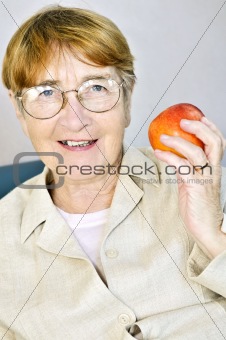 Elderly woman with apple