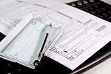 Preparing Taxes - Check and Forms on Keyboard