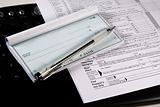 Preparing Taxes - Check and Forms on Keyboard