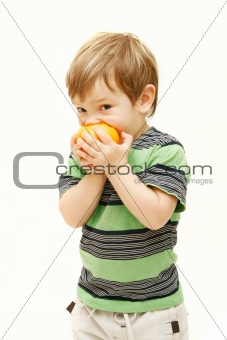 young boy eating orange over white