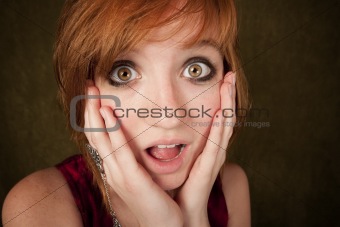 Shocked young girl on a green background
