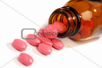 Medicine pills spilling from a bottle