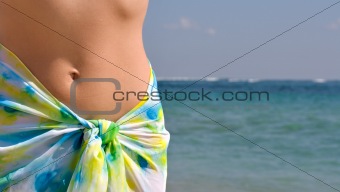 Woman belly and ocean