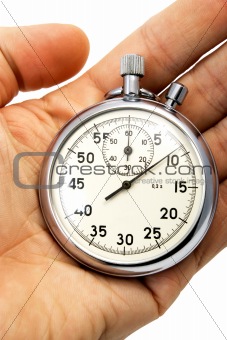 old mechanical stopwatch lying on hand 