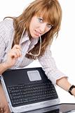The young woman in glasses sits with the laptop. Isolated on whi