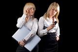 Two young businesswomen with laptop and phone. Isolated