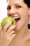 Young woman eating apple 
