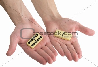 Bones of dominoes on male hands