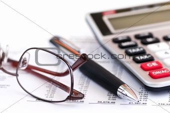 Tax calculator pen and glasses
