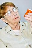 Elderly woman with pill bottle