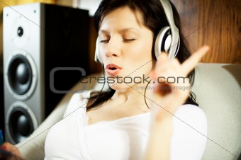 Beautiful woman listening music in headphones