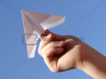 child hand with paper plane