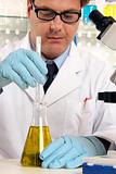 Scientist mixing liquids chemicals