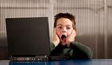 Shocked boy with a laptop computer