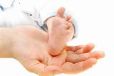 baby's foot on parents' hand