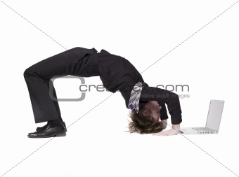 Acrobatic man in front of a computer