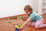 Adorable girl playing with blocks