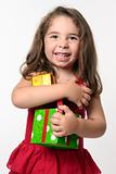 Jovial happy girl child holding presents