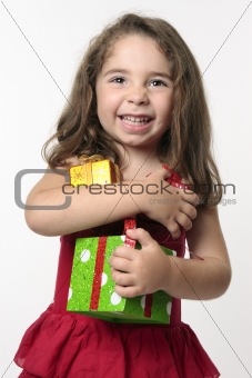 Jovial happy girl child holding presents