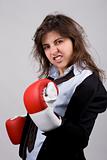 businesswoman wearing boxing gloves with confident attitude