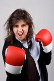businesswoman wearing boxing gloves with confident attitude