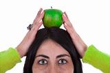 young woman holding healthy green apple above the head