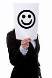 businesswoman holding smile printed funny face