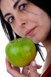 young woman holding green apple in the hand
