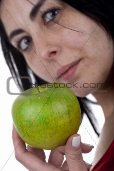 young woman holding green apple in the hand