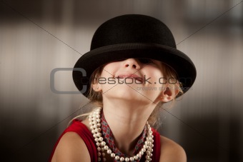 Girl with her face in her hat