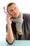 man with christmas hat talking on mobile