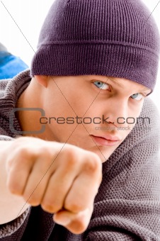 handsome man with winter cap showing fist