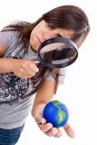 young woman holding small earth globe