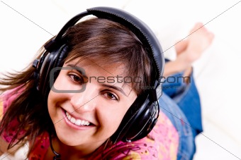 beautiful young woman listening music with headphones