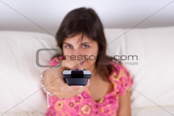 young woman holding television remote control