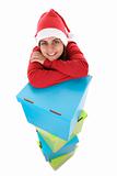 young santa woman posing with pile of present boxes